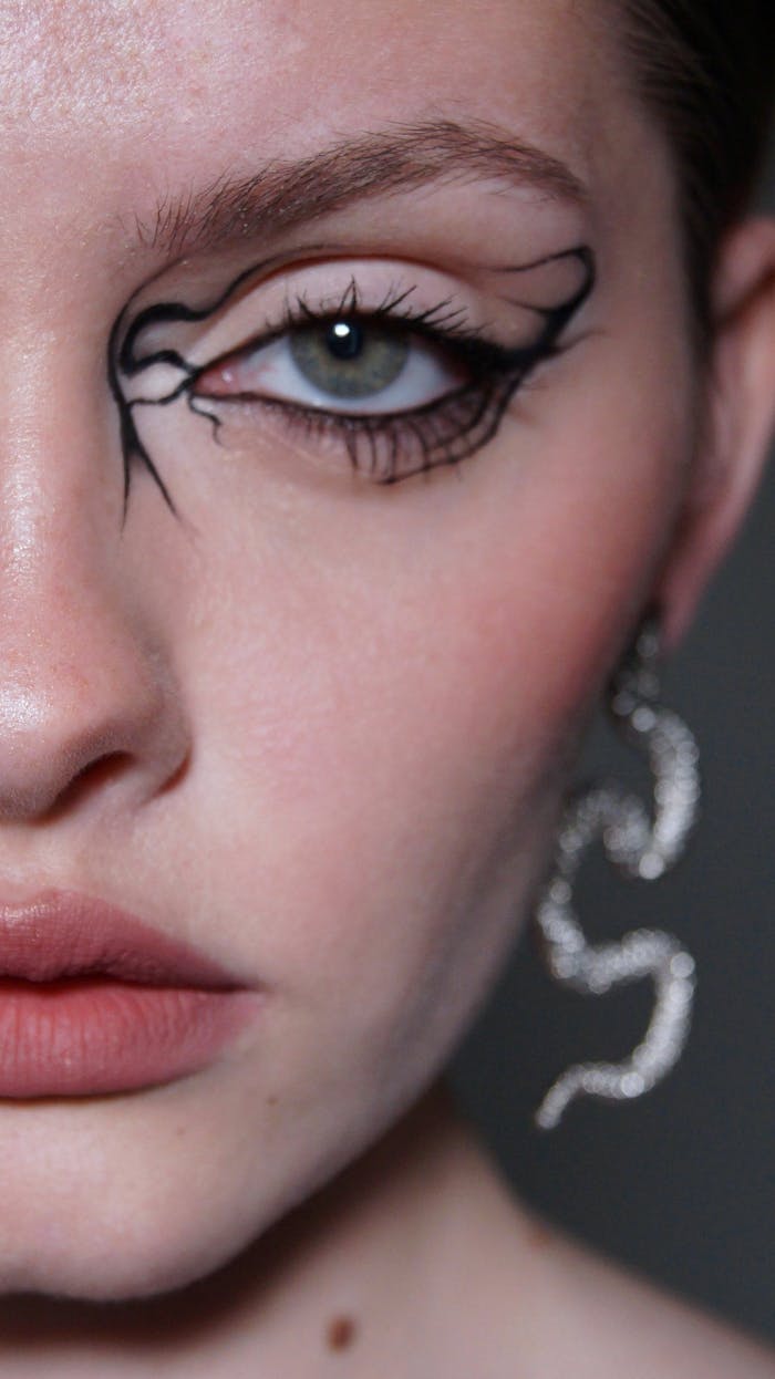 gallery-2 Close-up of a woman's eye with intricate artistic makeup design in Ukrainka, Ukraine.