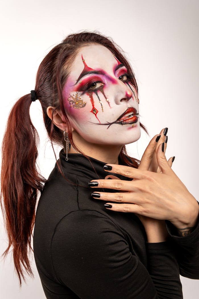 about-img Portrait of a woman with harlequin-inspired carnival makeup and black blouse, Mexico.